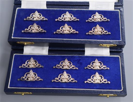 A set of twelve modern pierced scroll silver menu holders, by Mappin & Webb, Birmingham, 1988, in two cases.